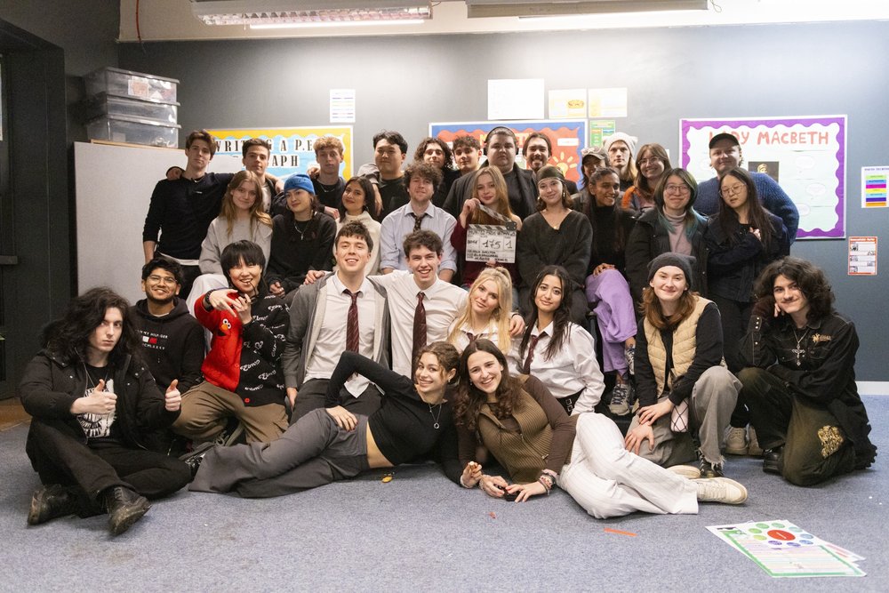 Full cast and crew group photo on set